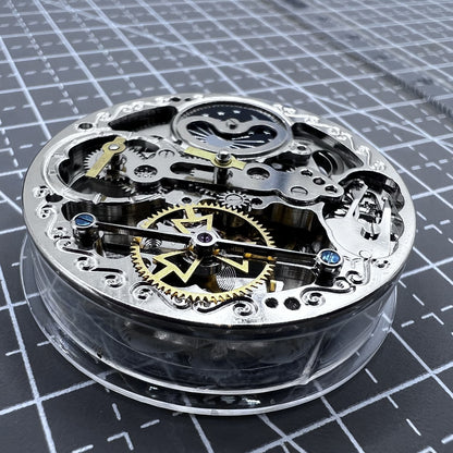 Small silver hollow watch movement with double mainspring and balance wheel at 6 o?clock by Kleines brand.
