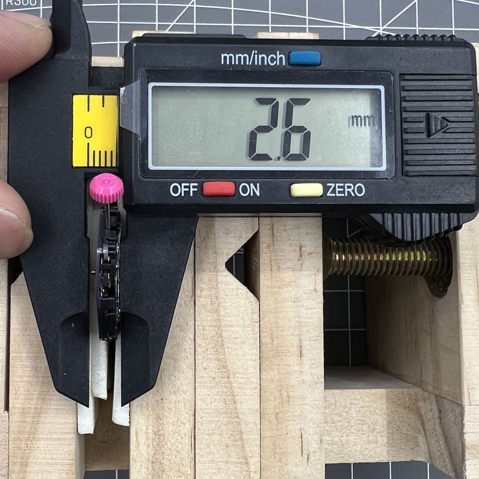 Close-up of Citizen Eco-Drive E168M quartz watch movement with 3 hands and date at 3 o'clock.