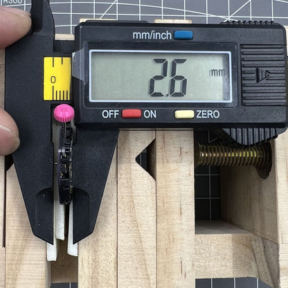 Close-up of Citizen Eco-Drive E168M quartz watch movement with 3 hands and date at 3 o'clock.