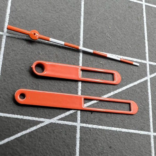 15mm Hollow orange and white trimmed watch hands for Ronda 515 movement, precise and stylish.