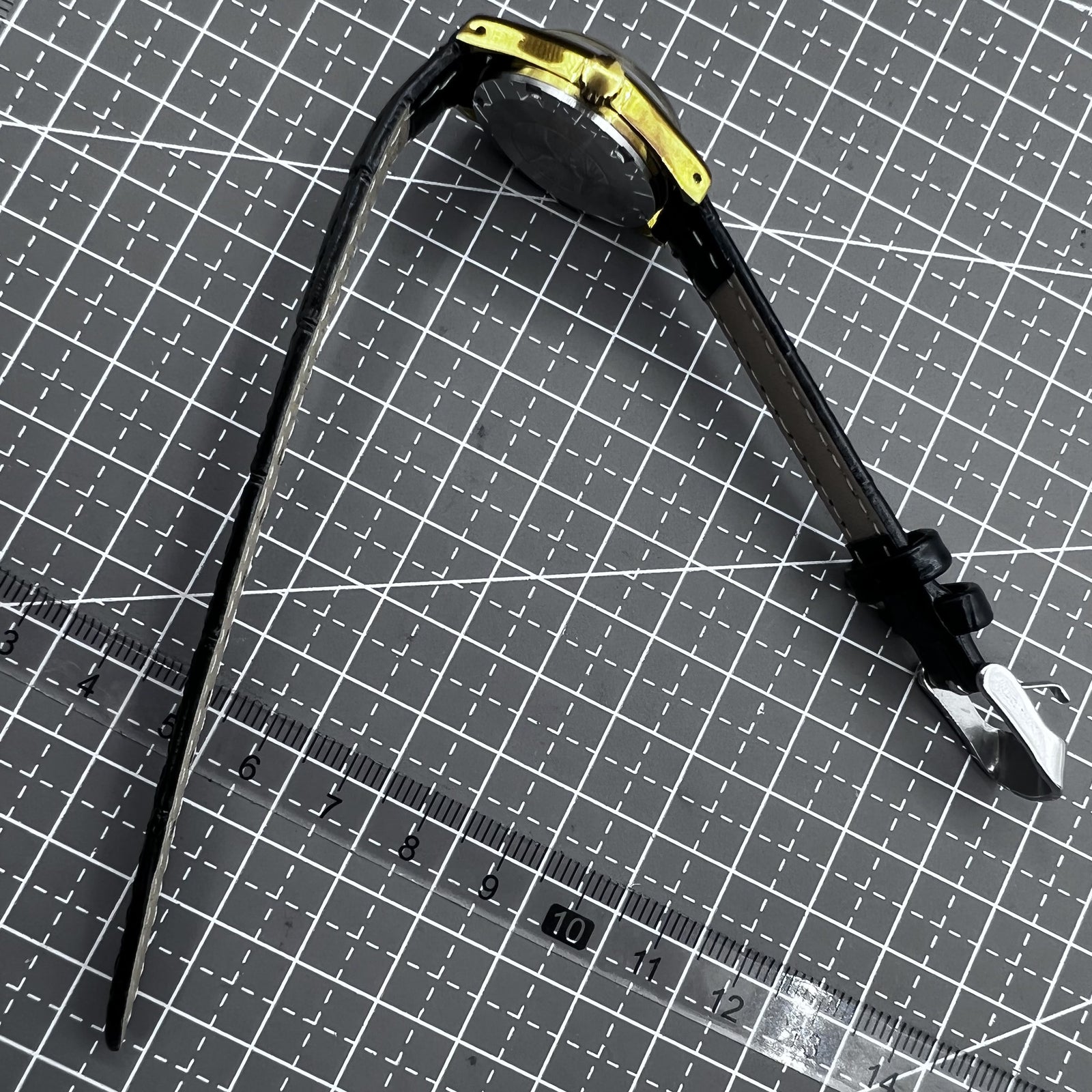 Black round case ladies watch with golden hour markers, Tianjin Seagull manual movement, elegant accessory.