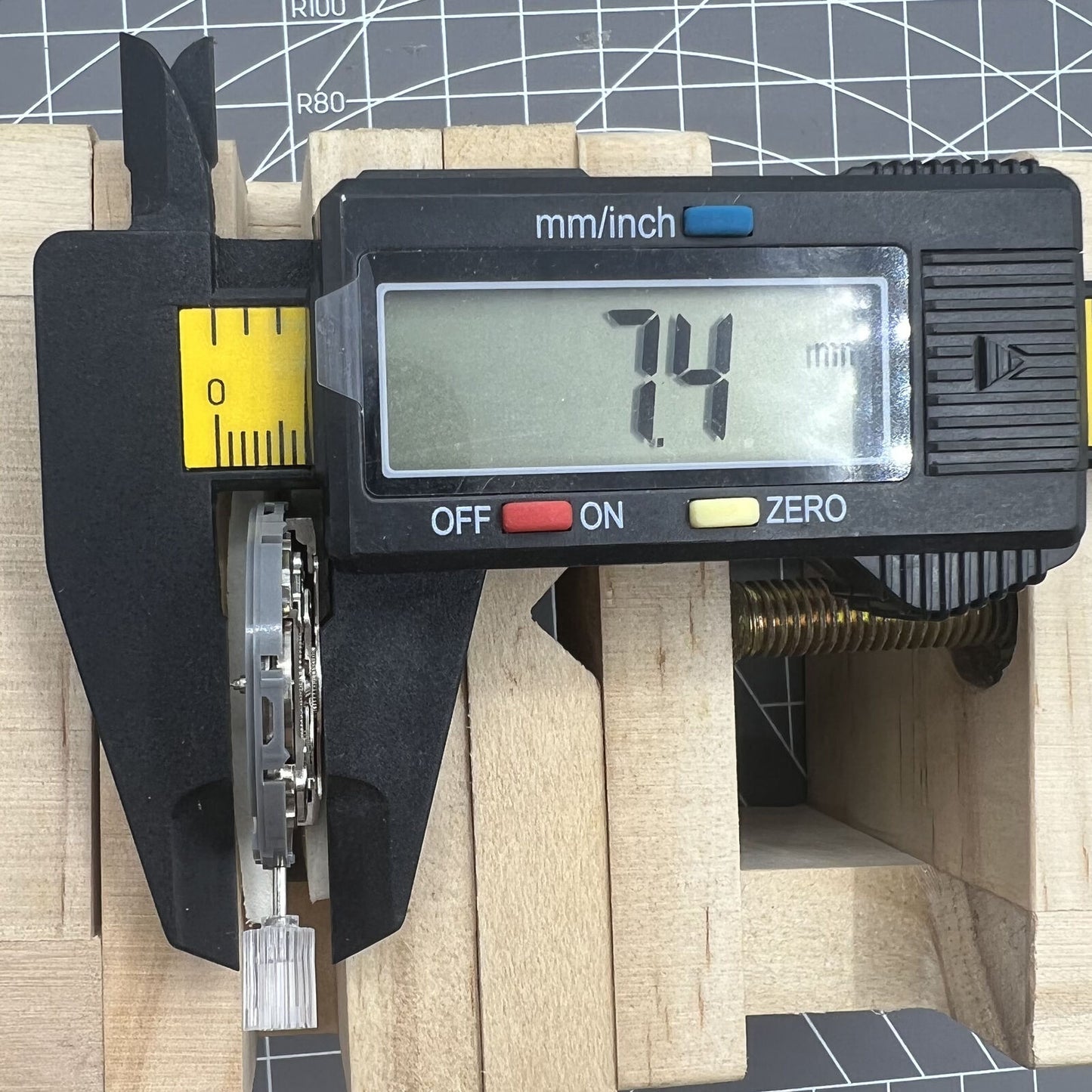 Seiko NH36A watch movement with white dial and blue lume, featuring 3/3.8 crown positions for accuracy.