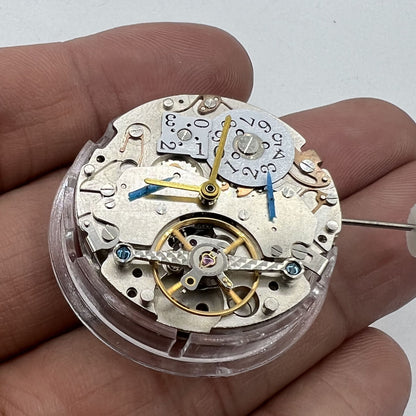 Asian multifunctional watch with date at 12, bare balance wheel, automatic mechanical movement.