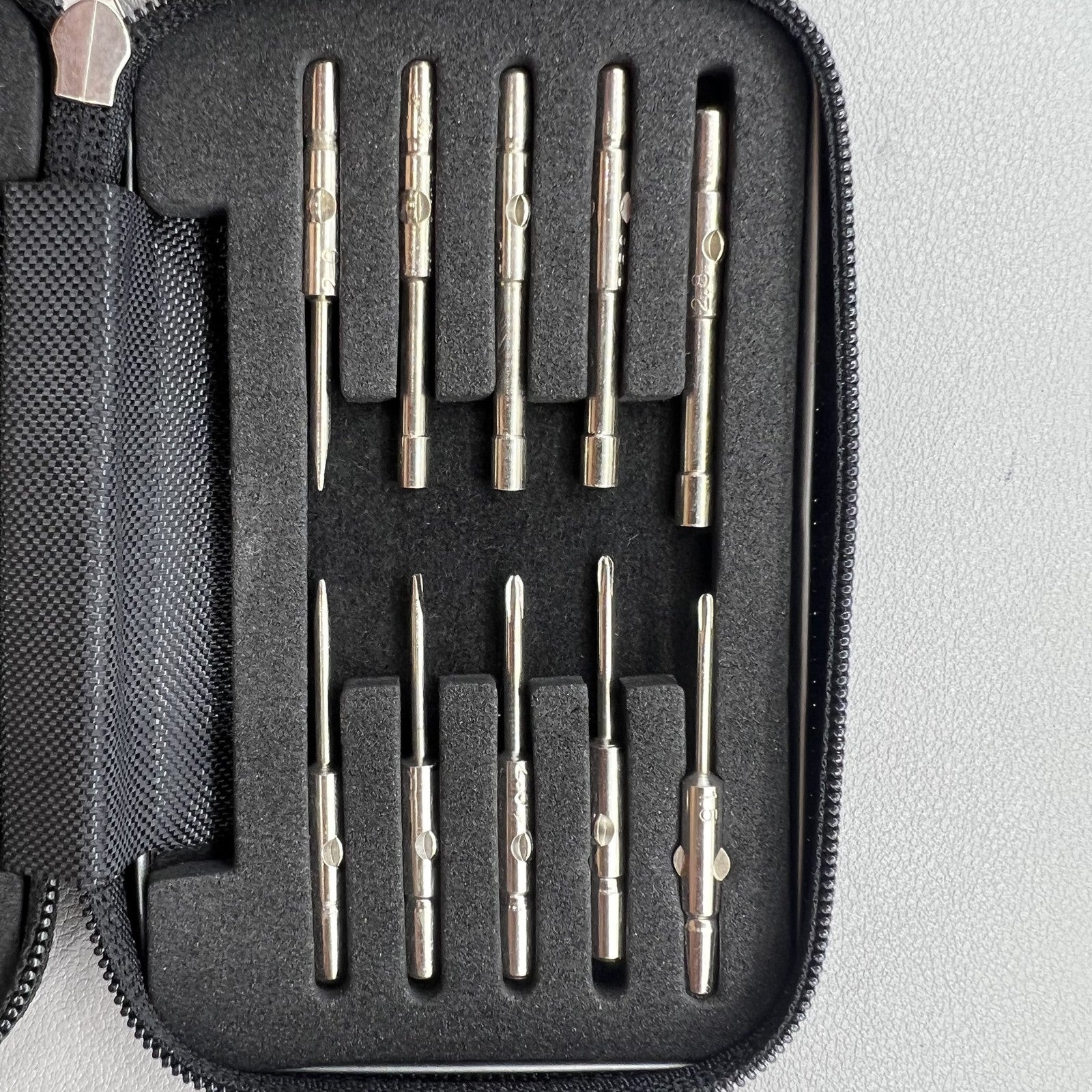 Precision screwdriver set for watch and eyeglass repair, includes hex tools and cutter heads with grip handle.