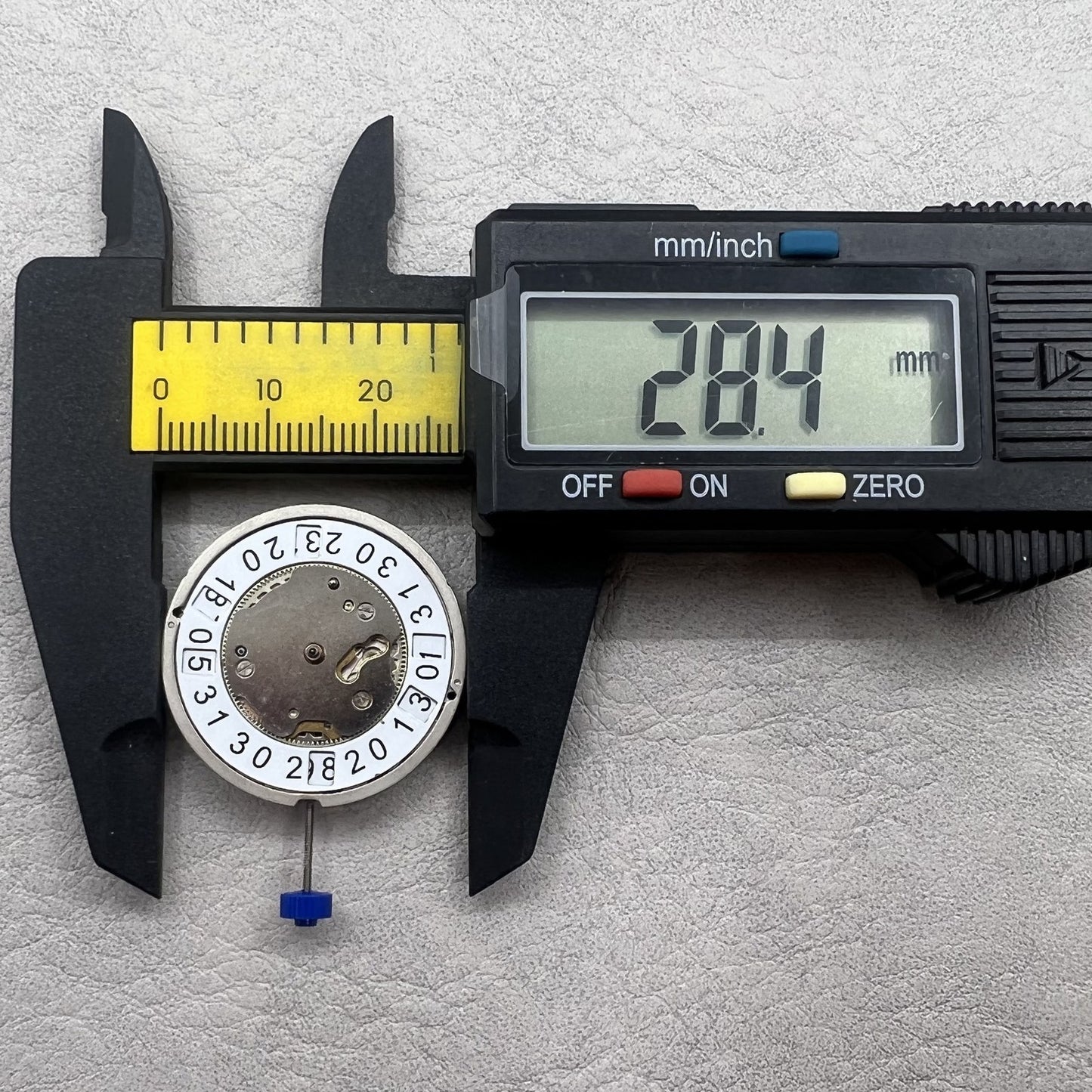 Swiss Ronda 5050B quartz watch movement with date at 6 o'clock and three hands for precise timekeeping.