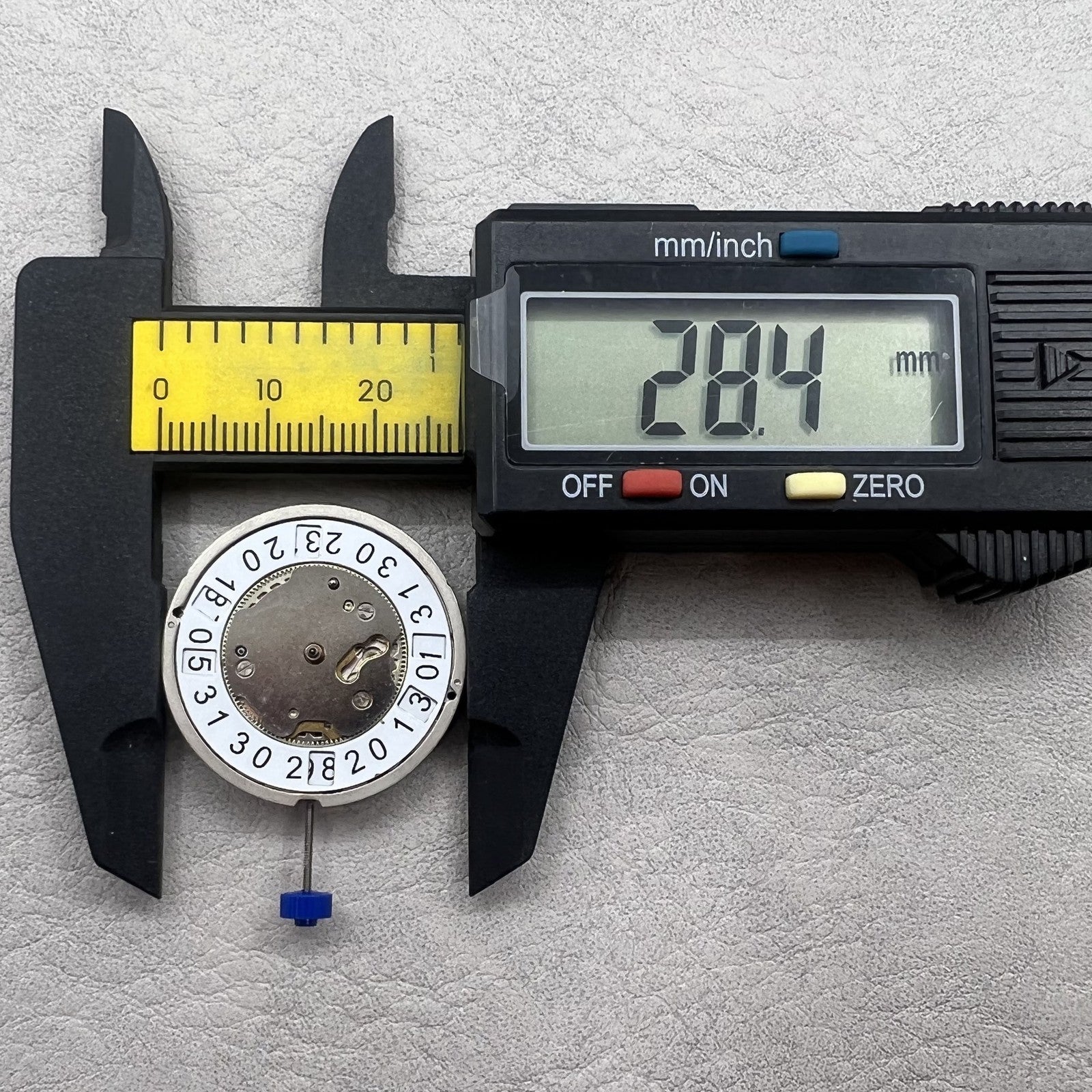 Swiss Ronda 5050B quartz watch movement with date at 6 o'clock and three hands for precise timekeeping.