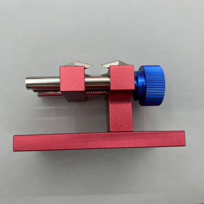 Professional watch bezel remover and case back opener tool for precise watch repair workbench.
