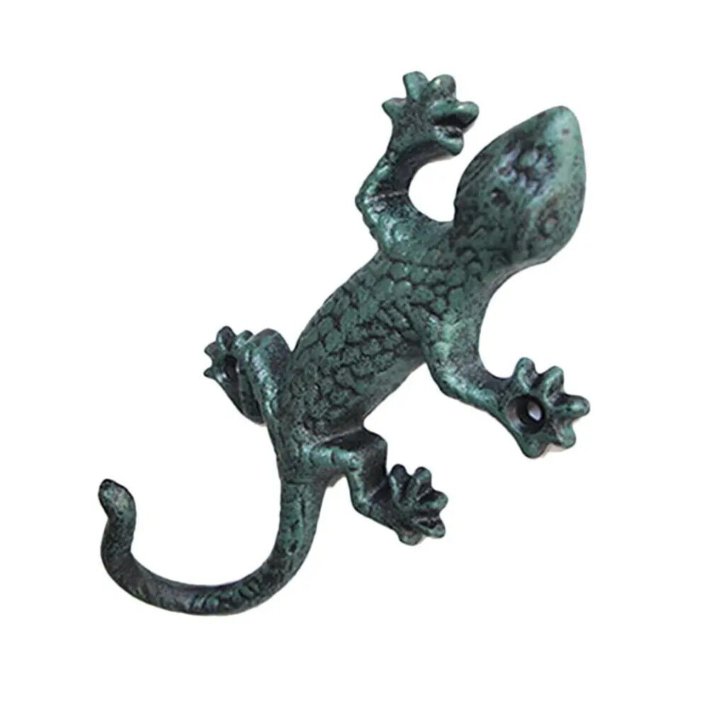 Vintage cast iron gecko-shaped wall hook, rustic and durable for hanging cloth or garden tools.
