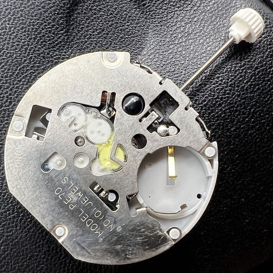 Sunon PE70 quartz watch movement with date at 3 o'clock, three hands, and subdials at 6, 9, 12 positions for precise timekeeping