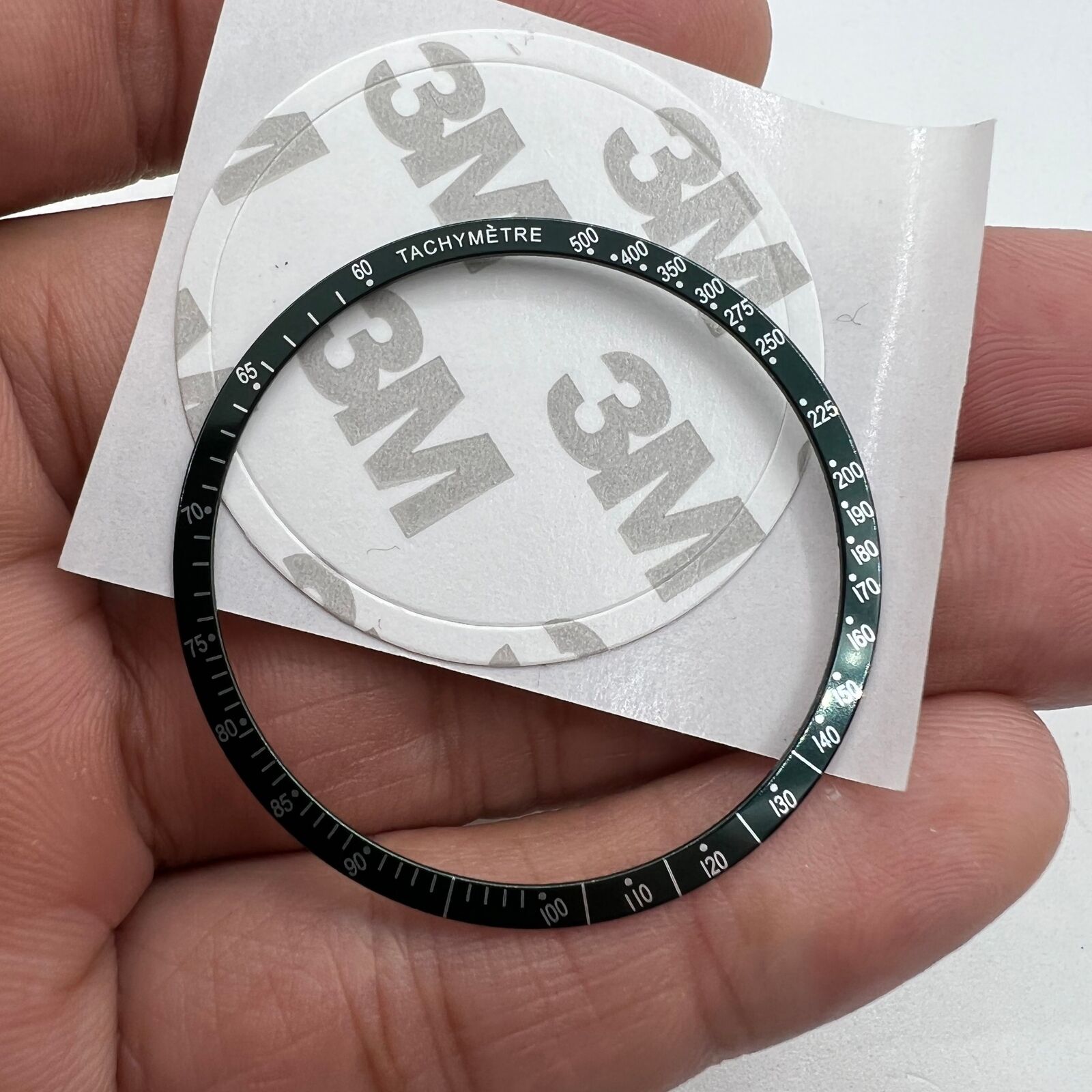 Green 38.5mm aluminum alloy bezel with white font for Omega Speedmaster, durable watch accessory.