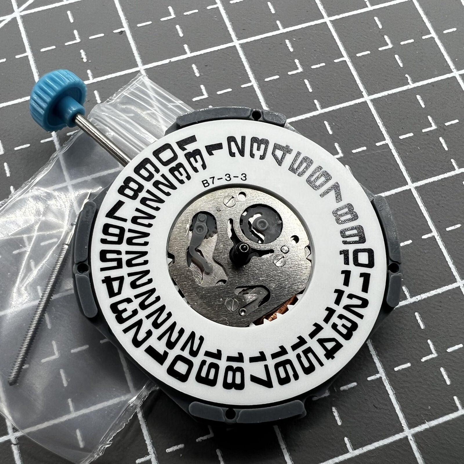 Miyota 6M53 quartz watch movement with big date at 3 o'clock, featuring three hands for accurate time.