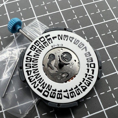 Miyota 6M53 quartz watch movement with big date at 3 o'clock, featuring three hands for accurate time.