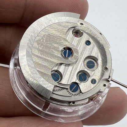 Asian automatic watch showcasing multifunctional date at 12 o?clock and exposed balance wheel, elegant design.