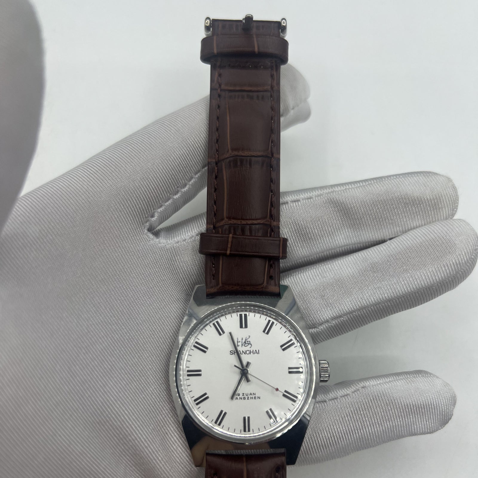Shanghai Factory 38mm manual mechanical watch with white dial, 3 hands, 19 jewels for accurate timekeeping.