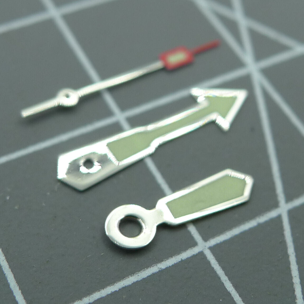 Silver-trimmed green lume arrow watch hand for Miyota 2035 movement, precise timekeeping accessory.