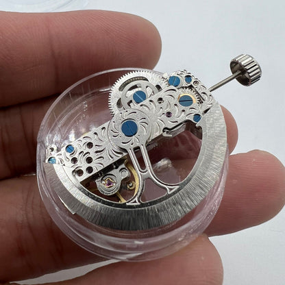 Silver long pendulum wheel watch accessory by Asian, showcasing automatic mechanical movement details
