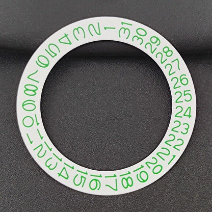 Close-up of NH35 NH36 watch movement with green date wheel on white background.