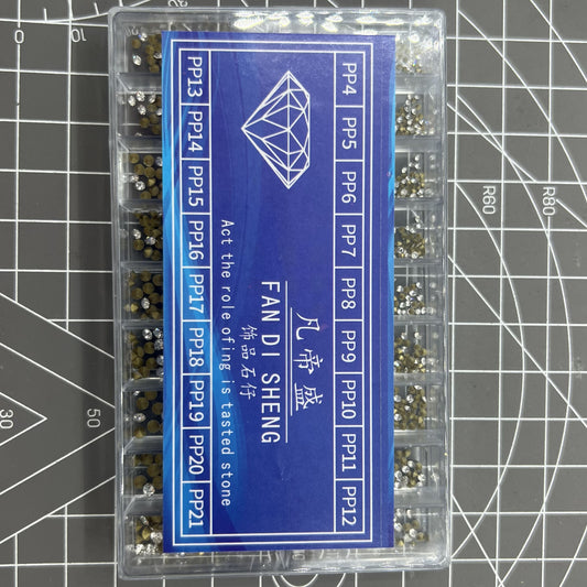 Box of 18 pointed bottom imitation diamonds for watch accessory decoration, perfect for DIY crafts.