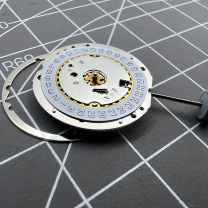 Swiss Made Ronda 784 quartz watch movement with date display at 3 o'clock for precise timekeeping.