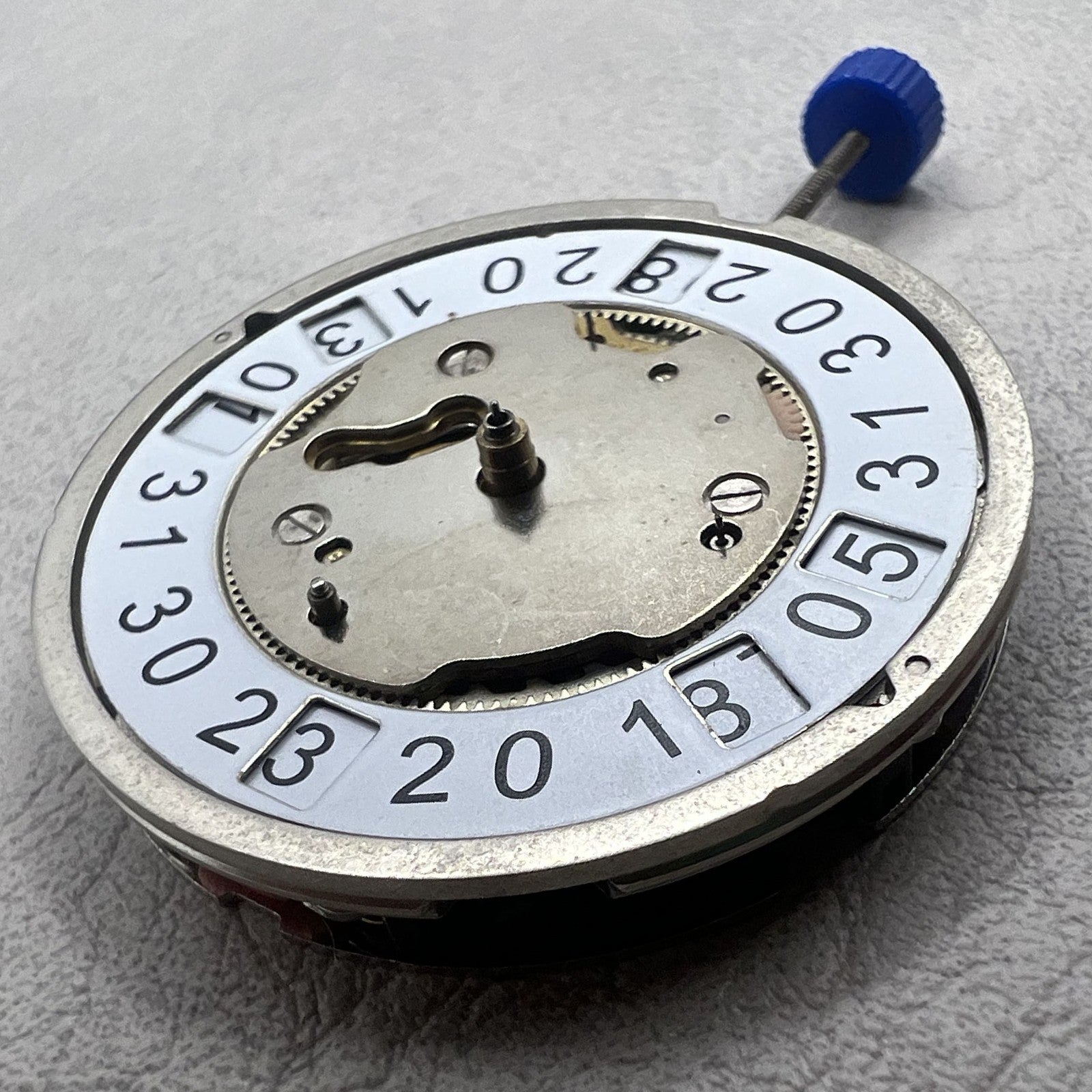 Swiss Ronda 5050B quartz watch movement with date at 6 o'clock and three hands for precise timekeeping.