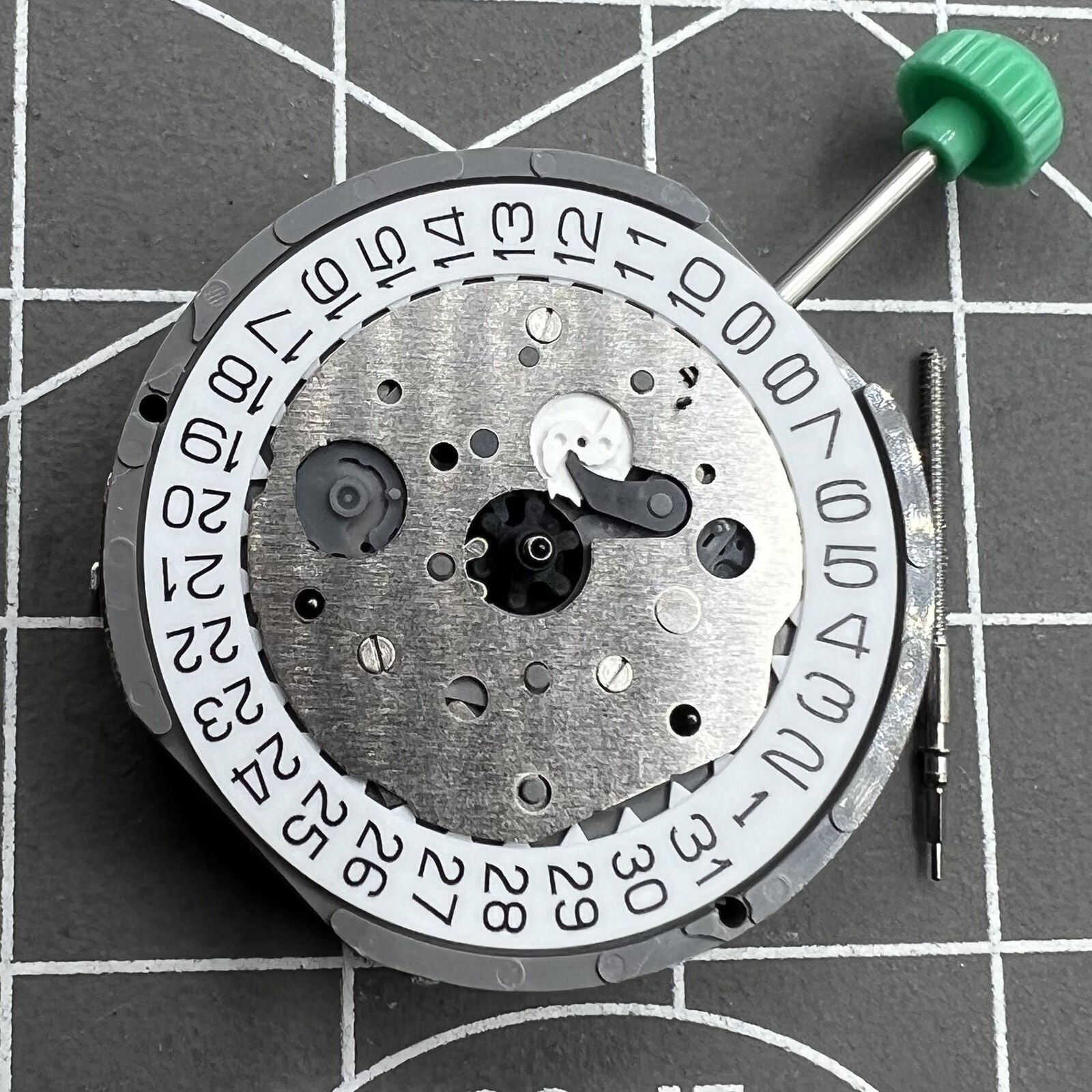 Miyota FS61 chronograph quartz watch movement with date at 4, three subdials, precise timekeeping.