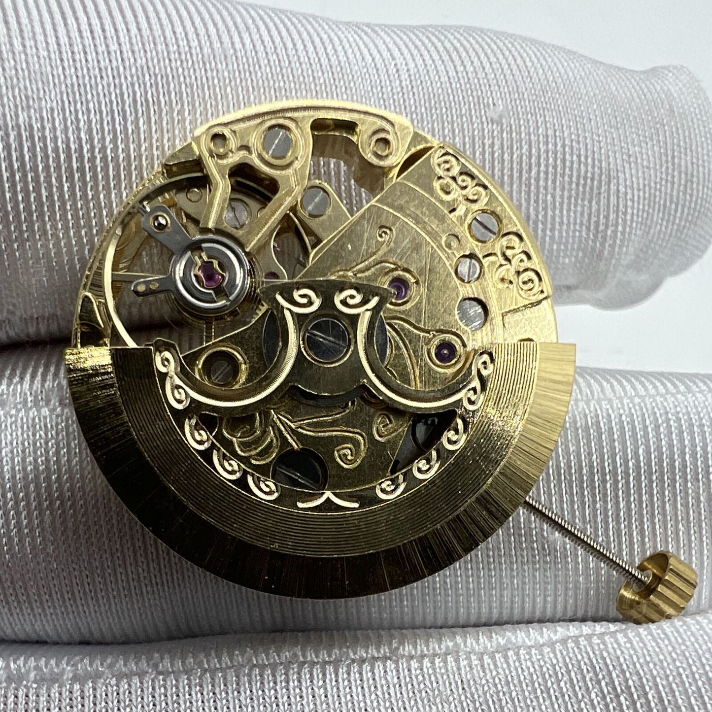 Golden 26.5mm 7120 automatic mechanical watch movement with carved hollow design, showcasing intricate craftsmanship and precision engineering.