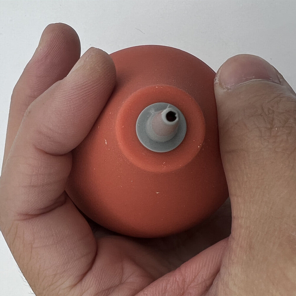 Bergeon 5733 rubber dust blower clearing fine watch components, essential for precise watchmaking maintenance.