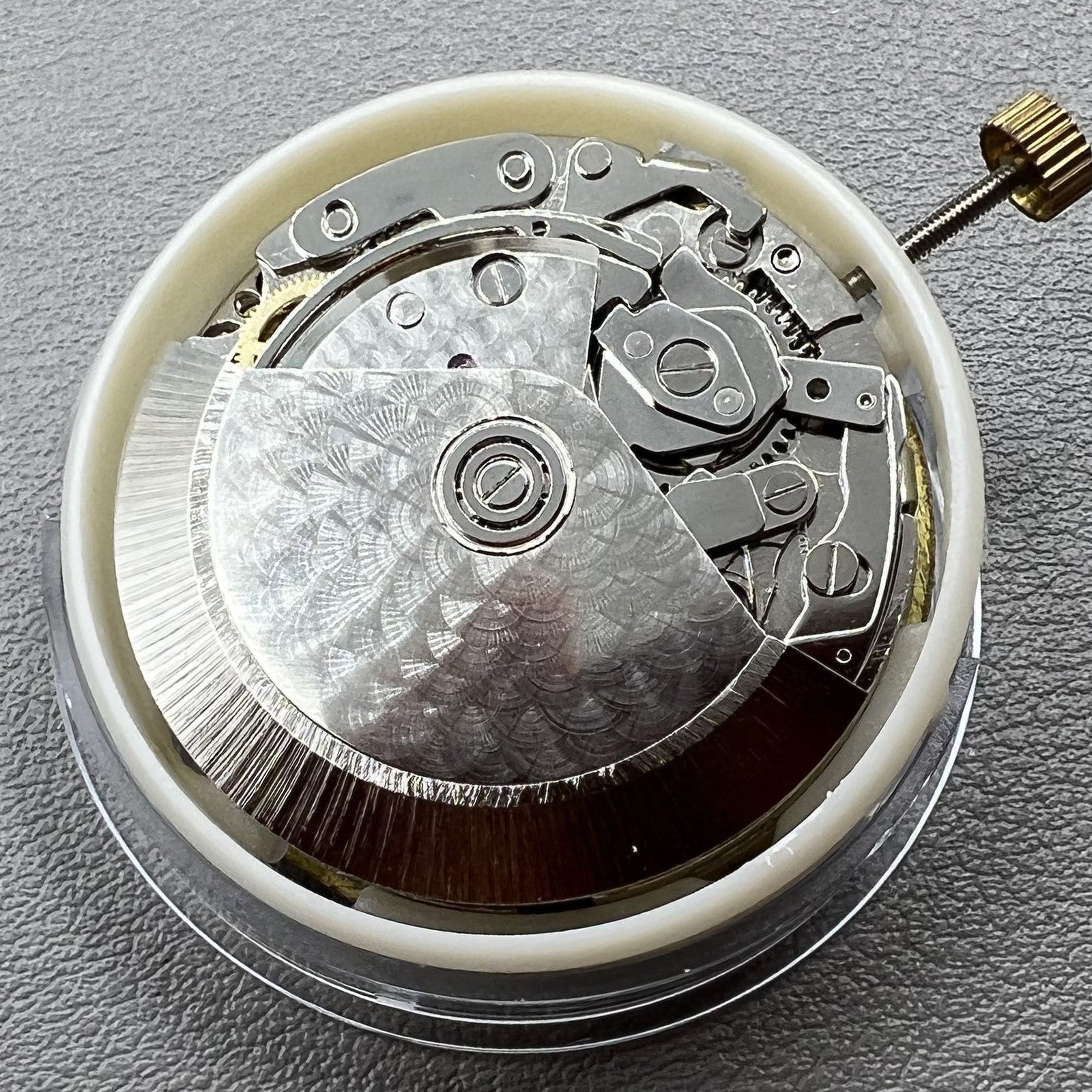 Dandong 7750 mechanical watch movement showing single calendar and small seconds at 6, 9, and 12 o'clock positions.