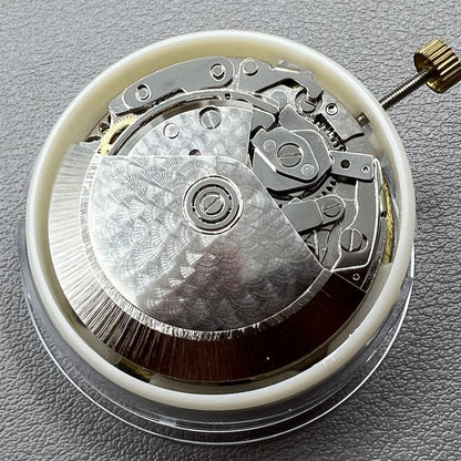 Dandong 7750 mechanical watch movement showing single calendar and small seconds at 6, 9, and 12 o'clock positions.