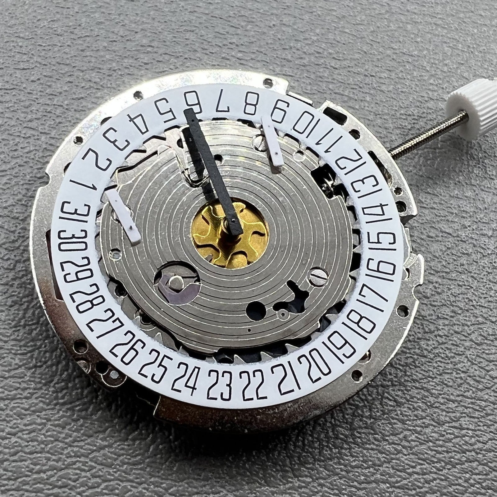 Swiss Made ISA 8171 silver quartz watch with 5 hands and date at 6 o'clock, elegant design.