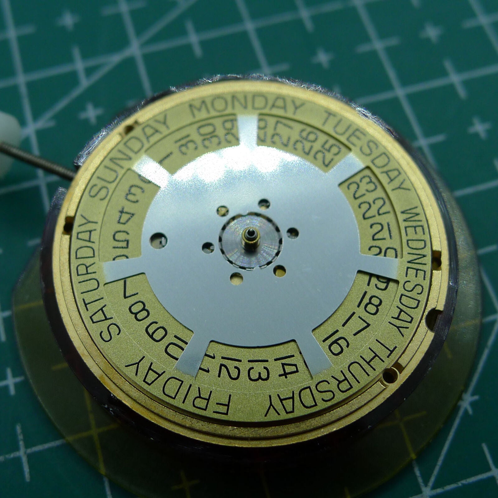 Swiss Made ETA 955.132 quartz watch movement showing double calendar with week at 12 and date at 3 features.