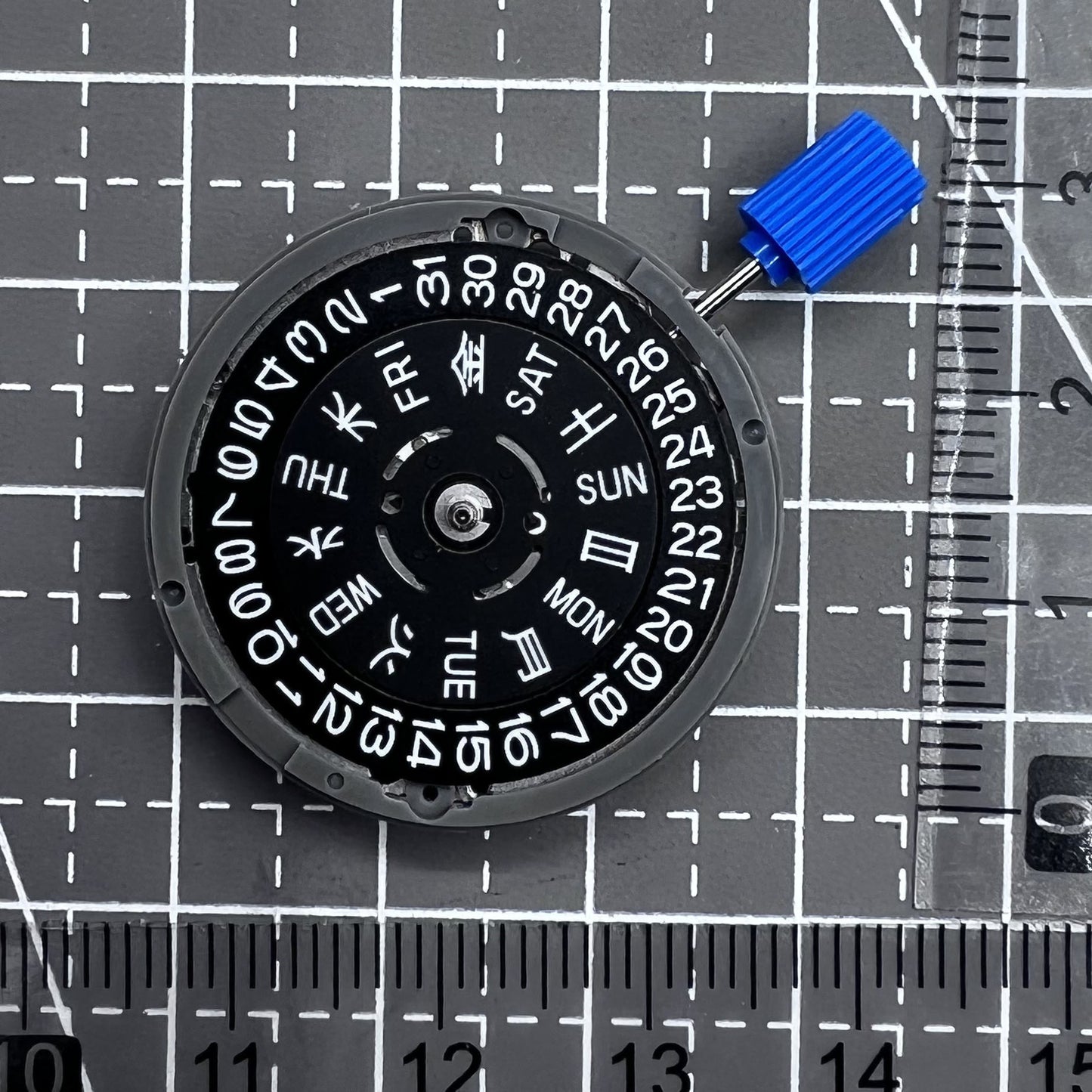 Seiko NH36A automatic watch movement with black finish and green luminescent markers, crown at 3:80 position.