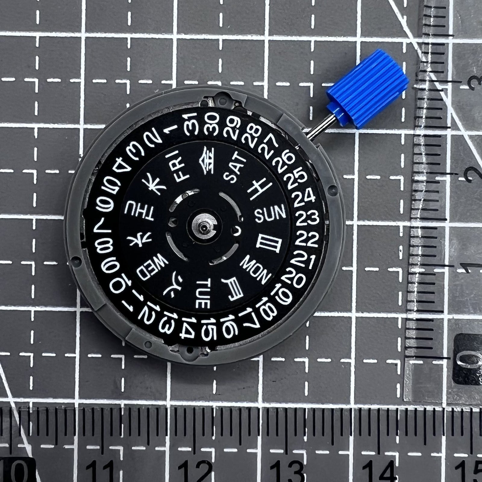 Seiko NH36A automatic watch movement with black finish and green luminescent markers, crown at 3:80 position.
