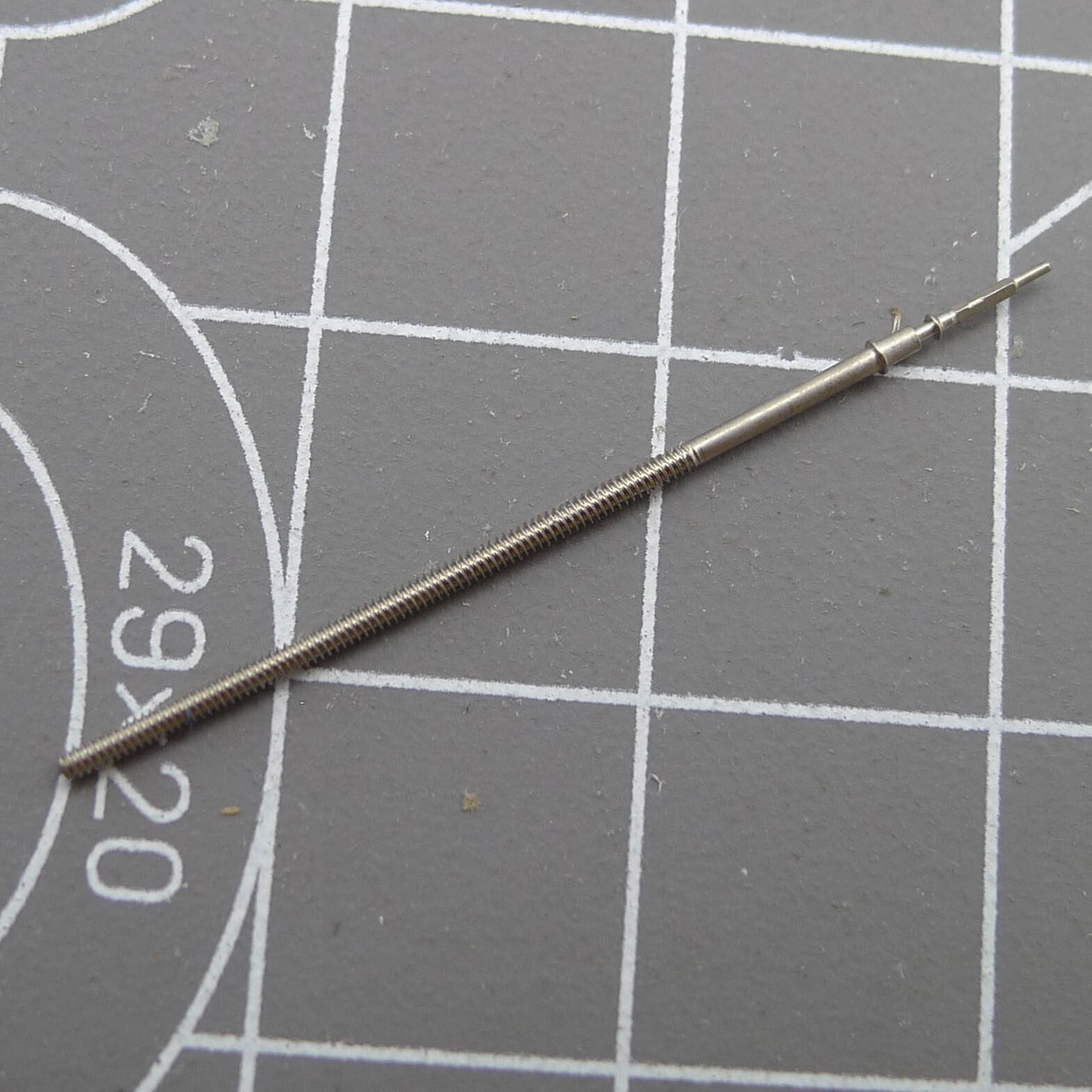 Replacement winding stem for Epson VR33 quartz watch movement, precise fit for accurate time adjustment.