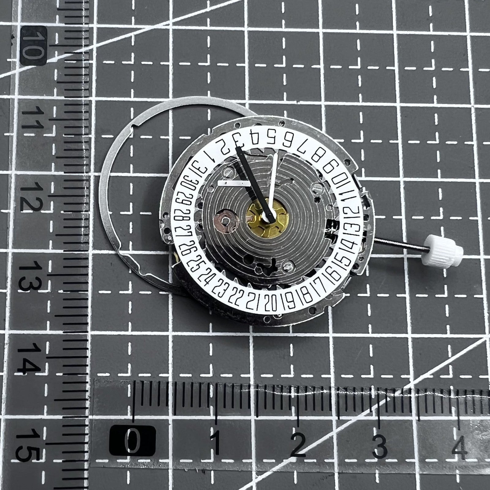 Swiss ISA 8171A quartz watch movement with white dial, four hands, and date at 6 o?clock for precise timekeeping.