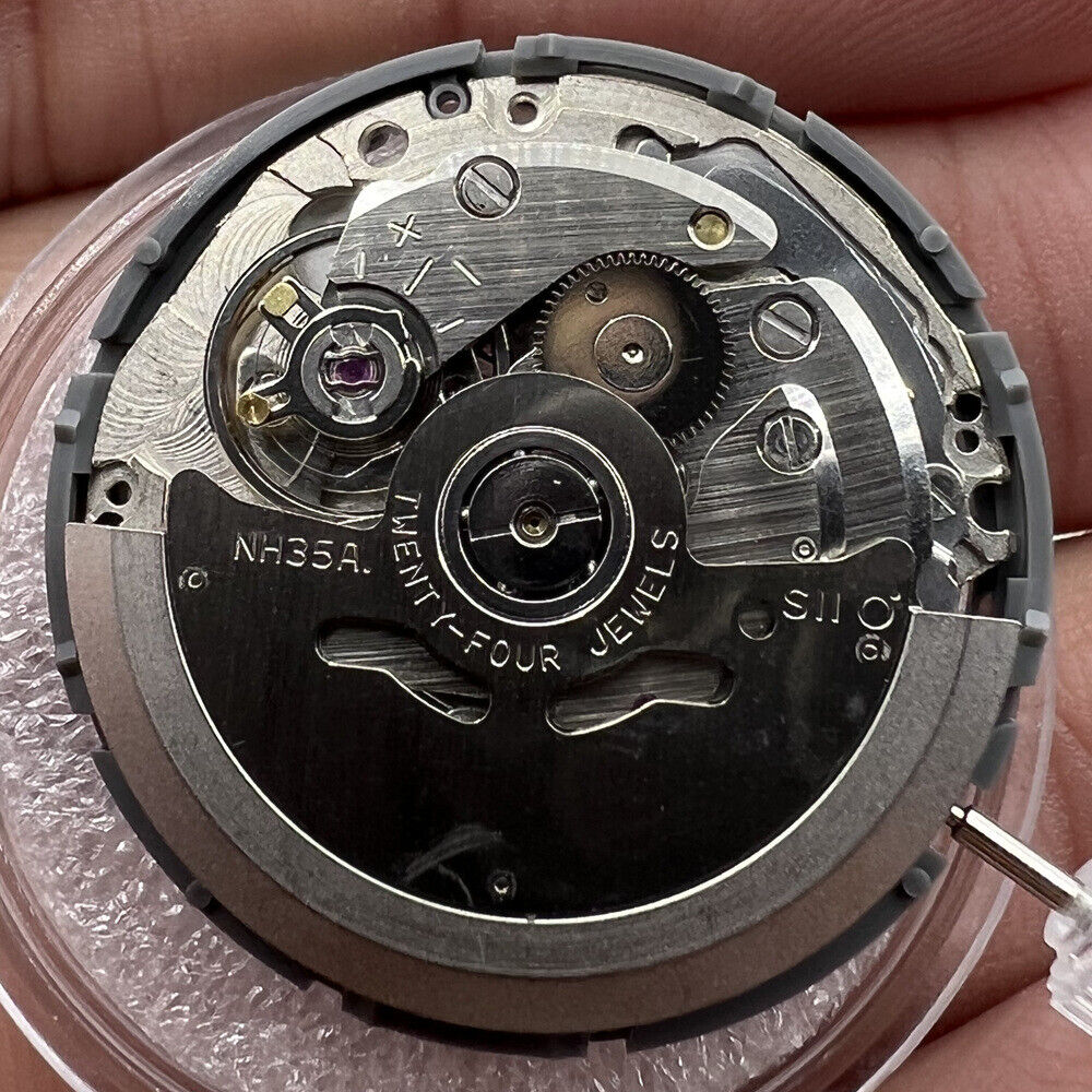 NH35A Japan automatic mechanical watch movement with golden date display, SKX007 style crown at 3 o'clock.