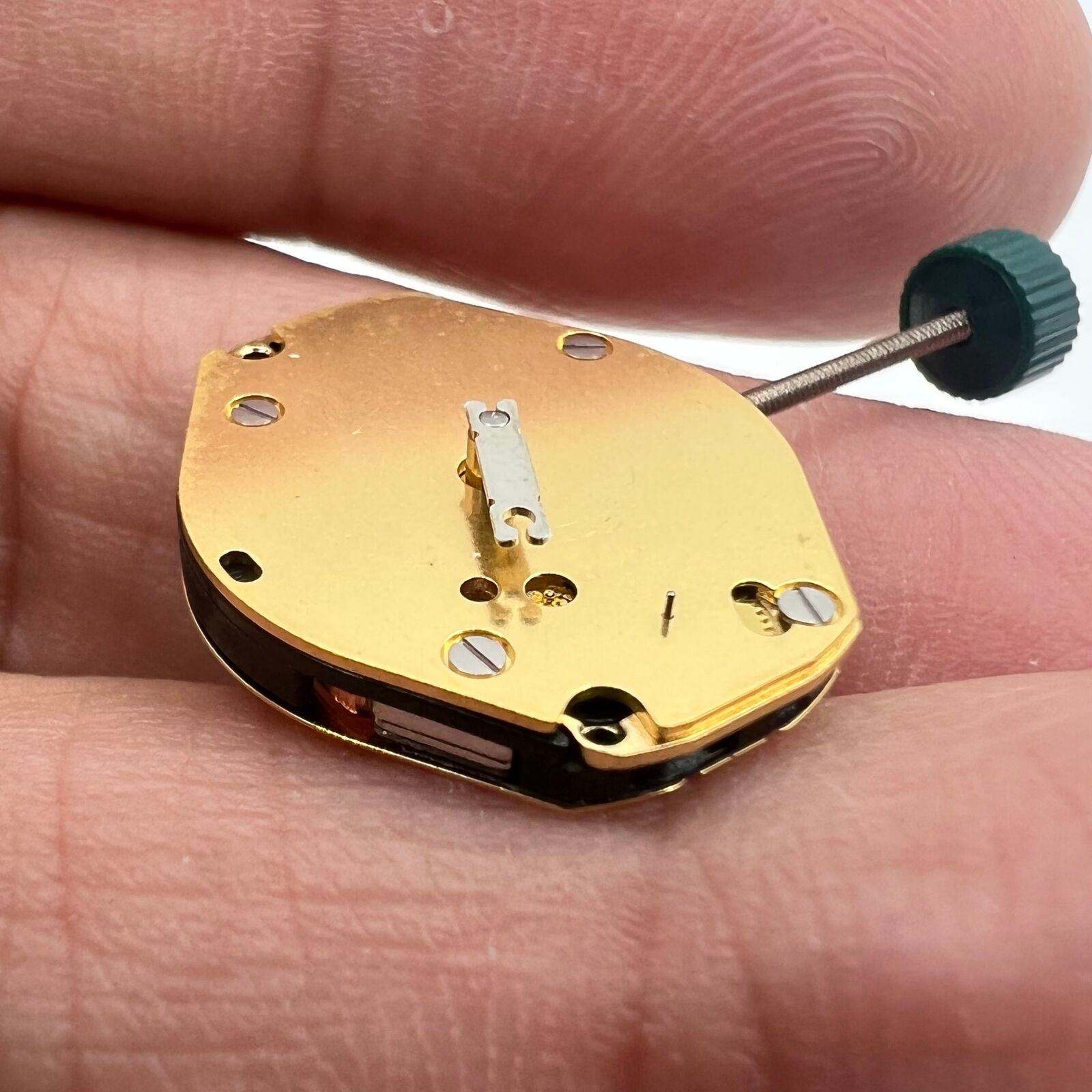 Ronda 1069 golden plated quartz watch movement, Swiss made, precision timekeeping component.