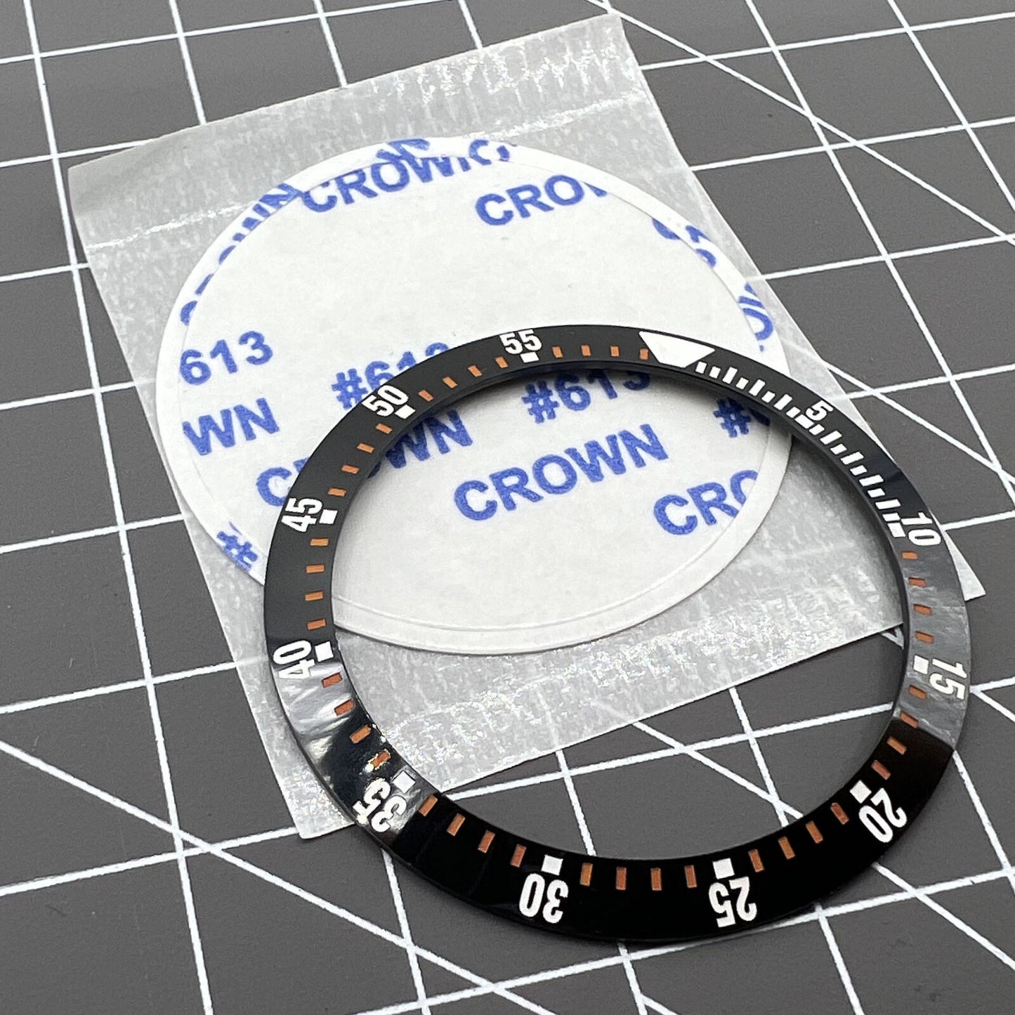 38mm black ceramic watch bezel insert with orange graduation for precise time tracking.