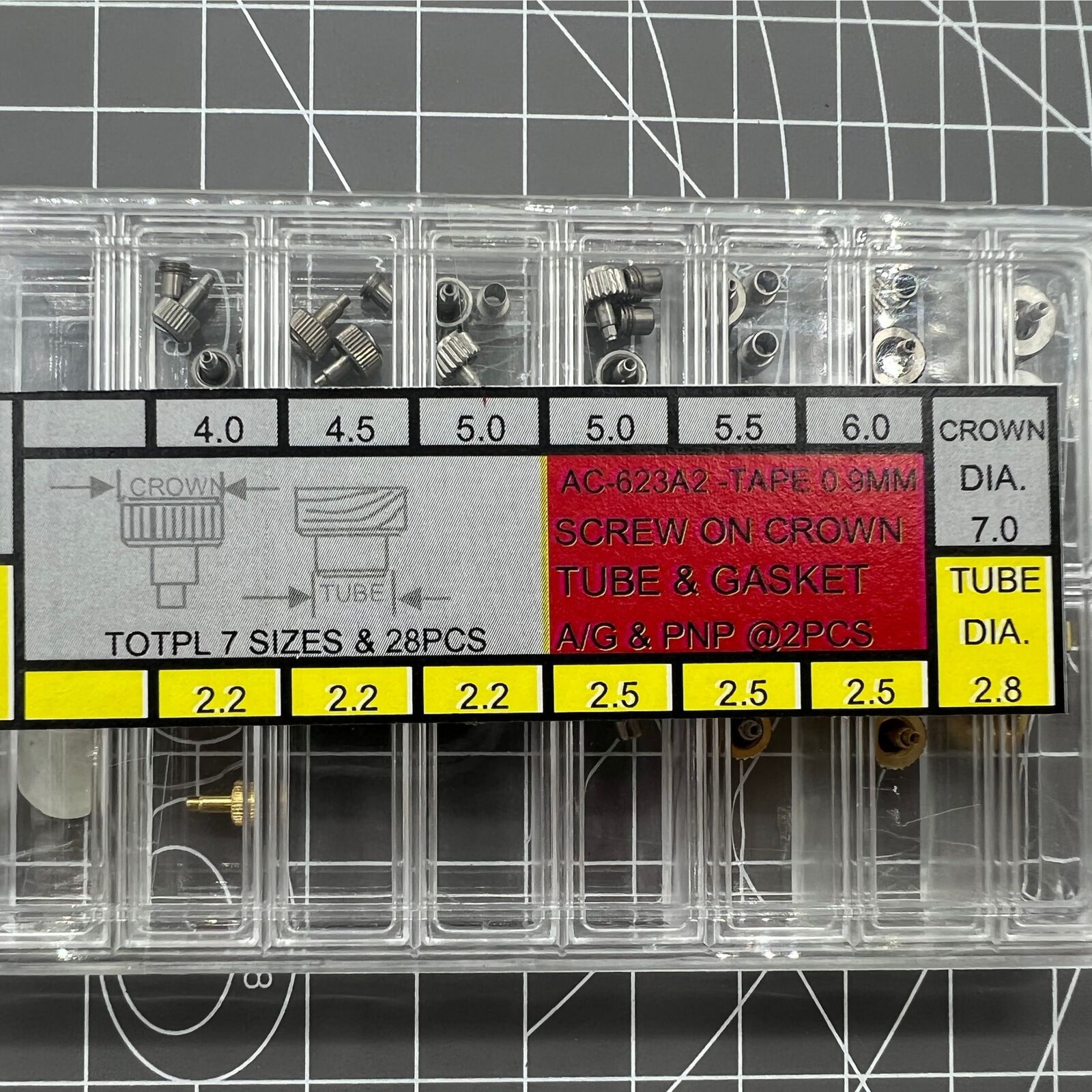 Silver and gold stainless steel watch crown with gasket, durable replacement for secure fit.