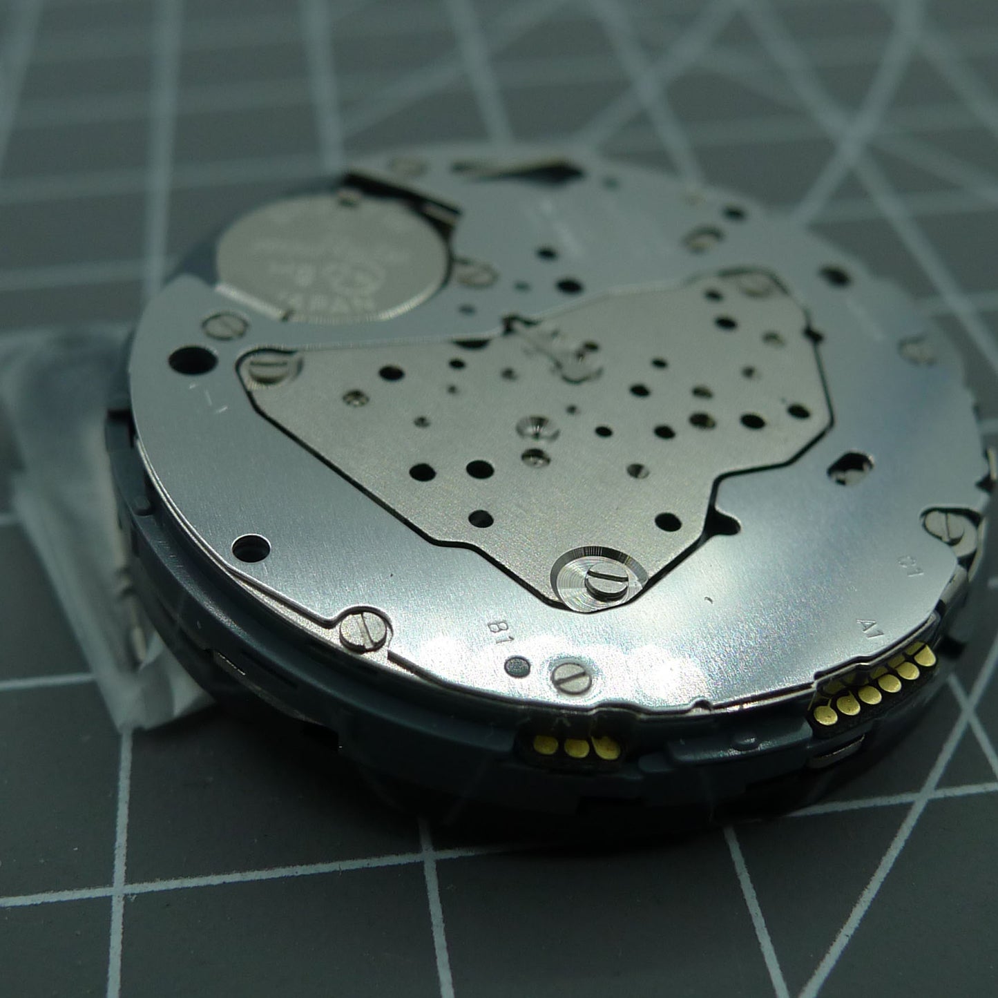 Miyota 6S50 quartz watch movement displaying date at 12 and small seconds subdials at 3, 6, 9 positions