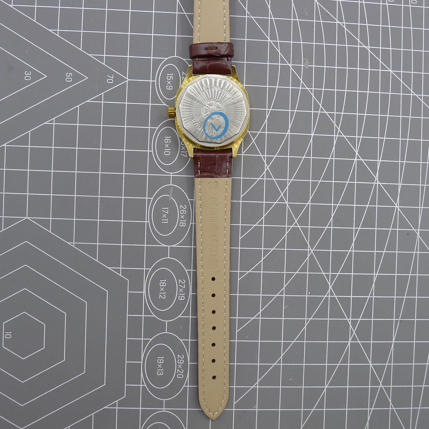 33mm Shanghai watch with blue dial and golden nail markers in square case, manual movement, 17 jewels.