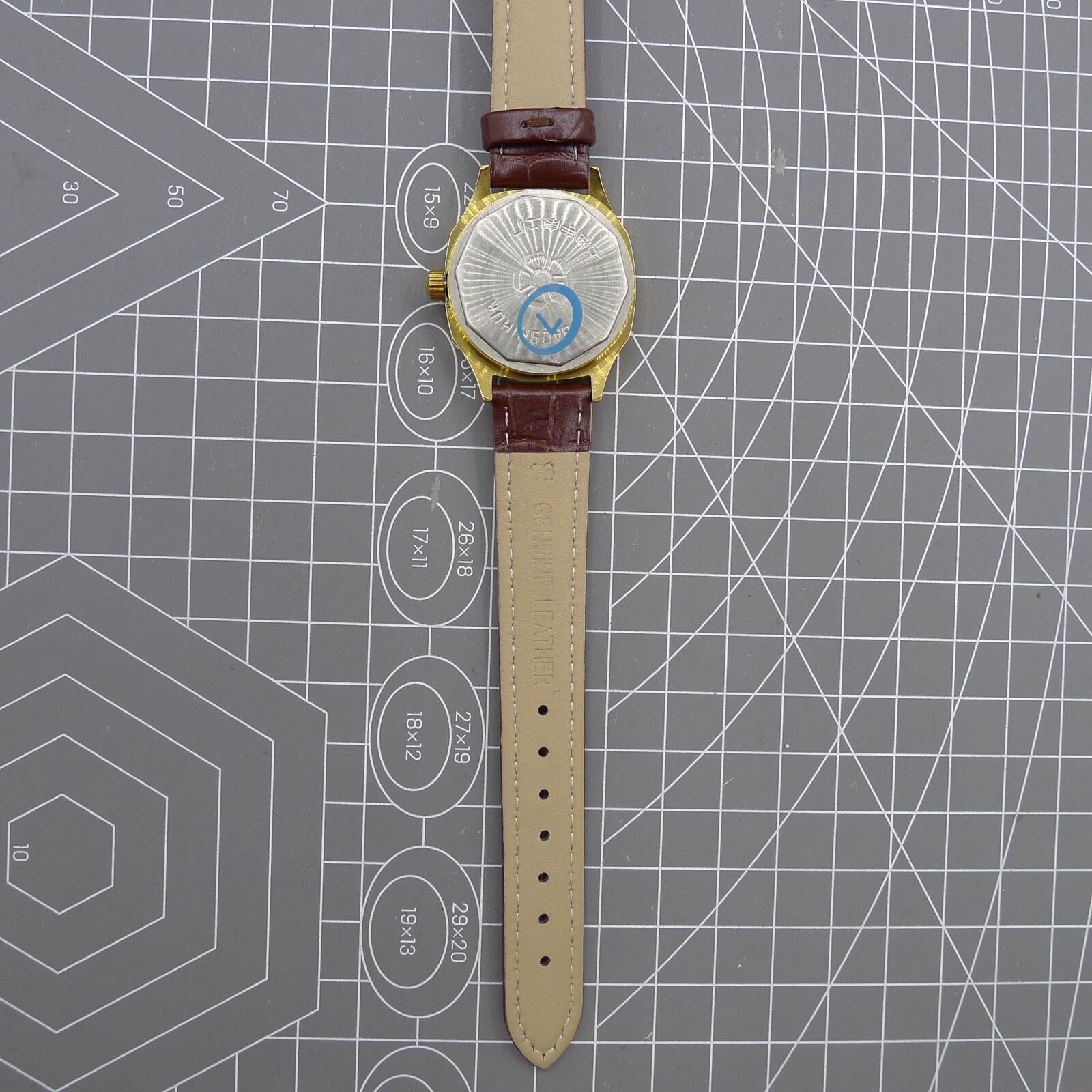 33mm Shanghai watch with blue dial and golden nail markers in square case, manual movement, 17 jewels.