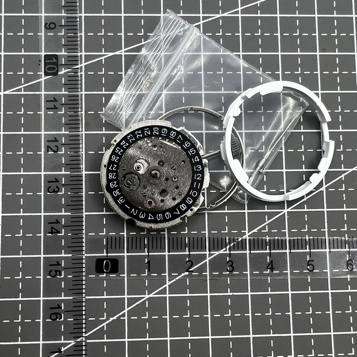 Citizen Miyota 8215 automatic mechanical watch movement with black dial and date display at 3 o'clock.