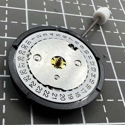 Swiss ISA Quarzuhrwerk K83 103 watch movement with date at 3 o'clock and three hands for precision timekeeping.