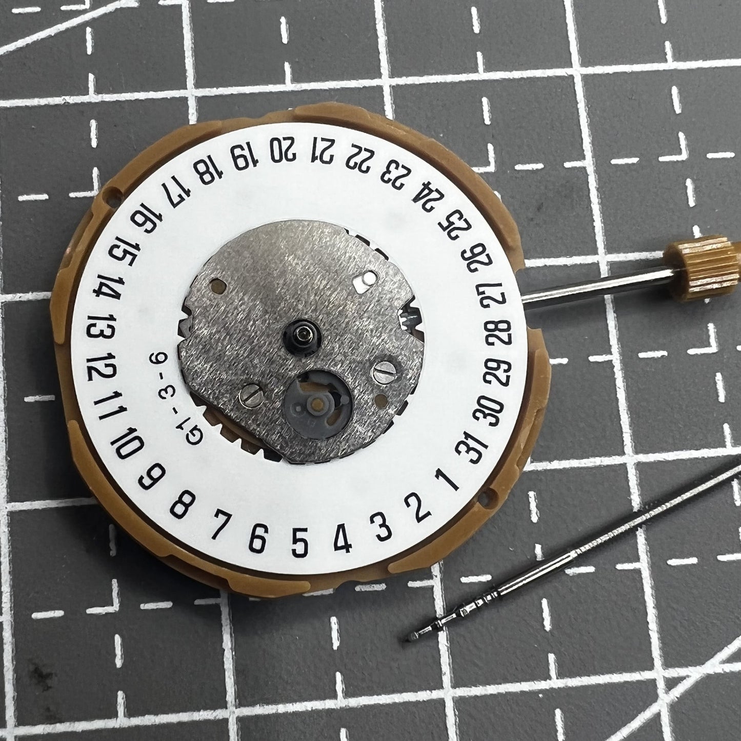 Japan Miyota GM10 watch movement with date display at 6 o'clock, precise quartz mechanism.
