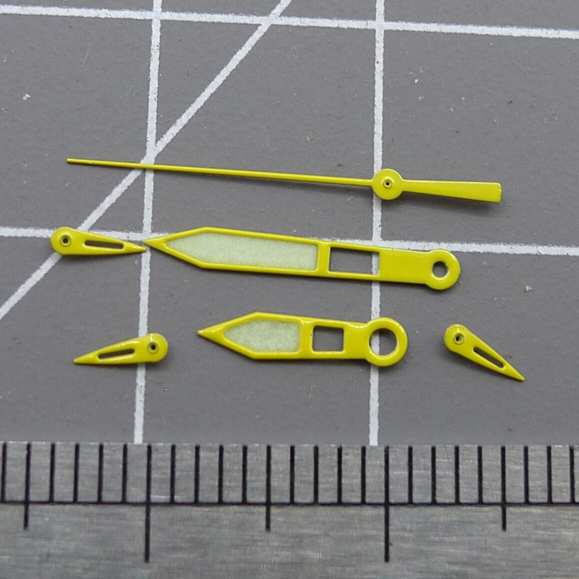 Yellow-trimmed green lume watch hands for Miyota OS10 movements, precise timekeeping accessory.