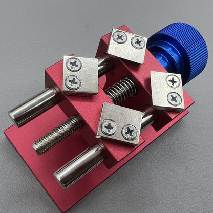 Professional watch bezel remover and case back opener tool for precise watch repair workbench.