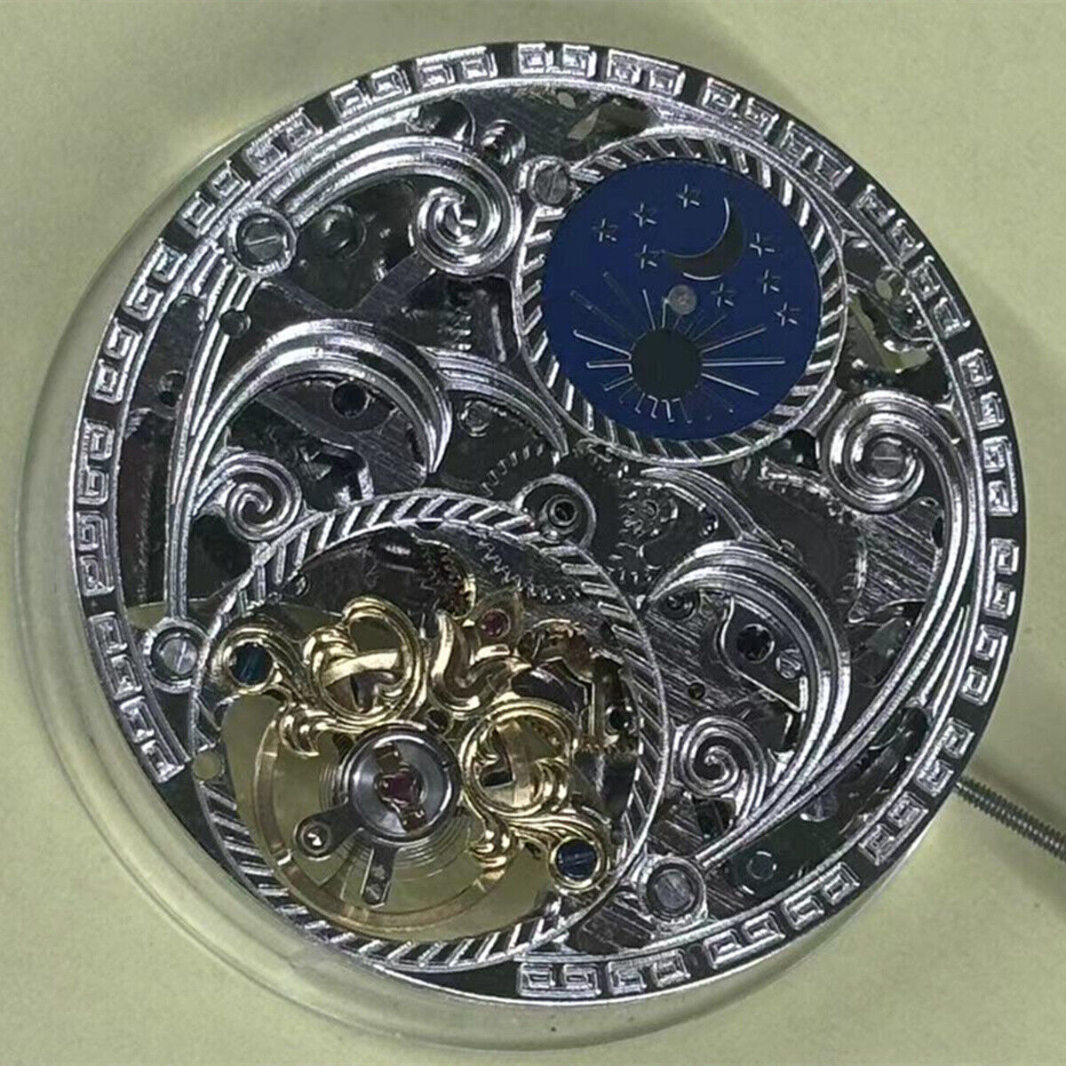 Hollow automatic mechanical watch part with moon phase at 12, China-made precision movement.