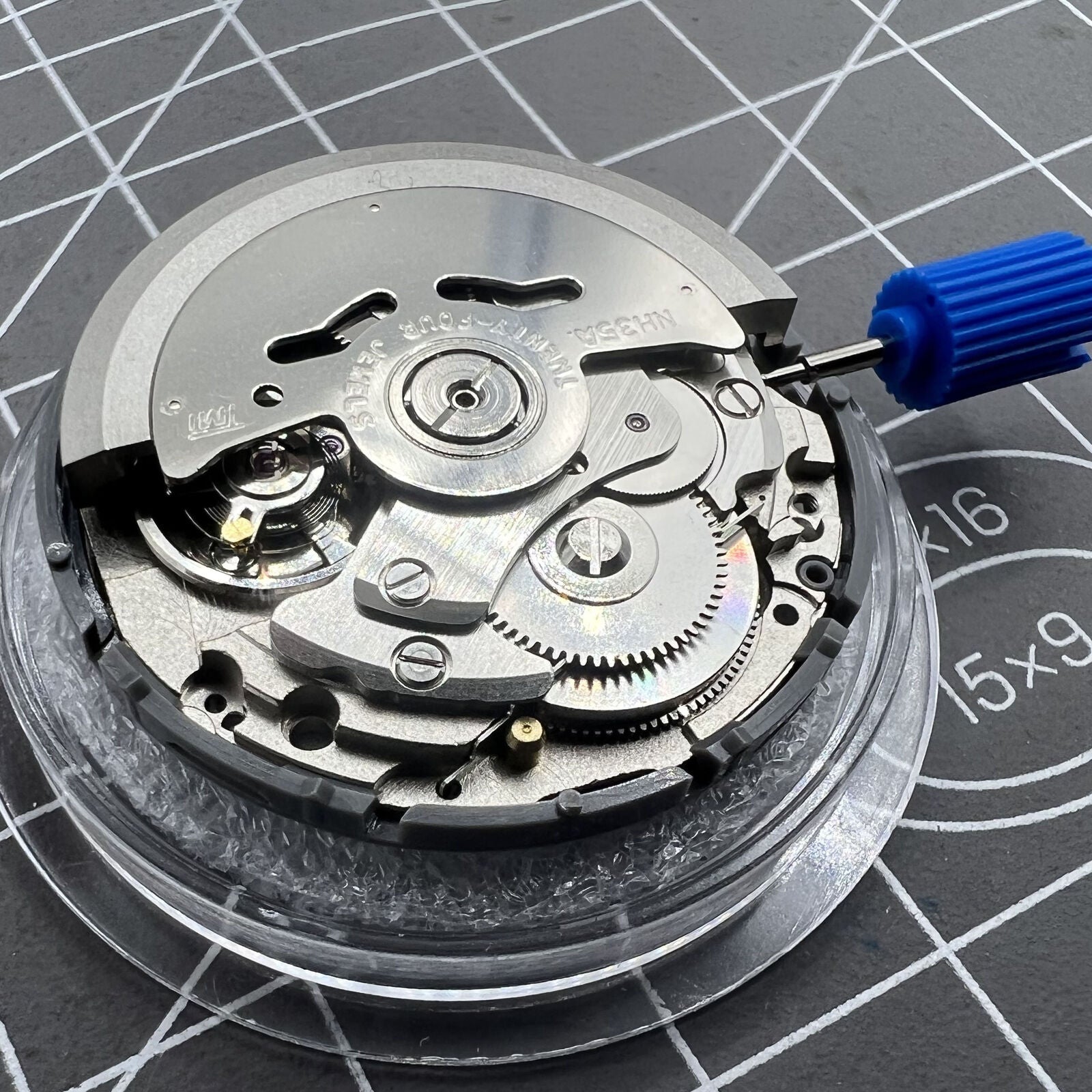 Black NH35 Seiko automatic watch movement with date at 6, precise self-winding mechanical mechanism.