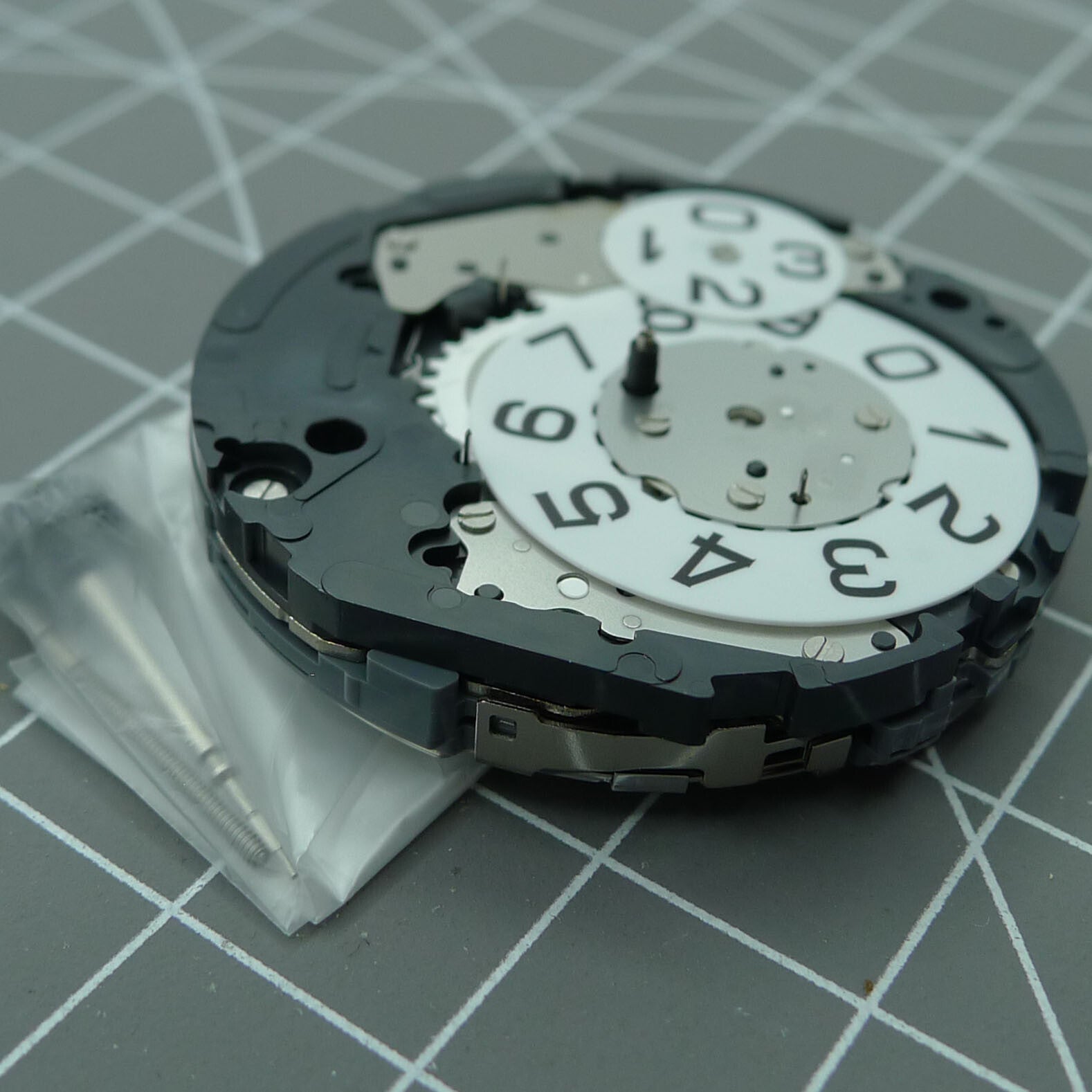 Miyota 6S50 quartz watch movement displaying date at 12 and small seconds subdials at 3, 6, 9 positions for precision timekeeping